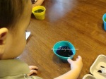 ds waiting for the egg to change color; egg was just dunked in the cup